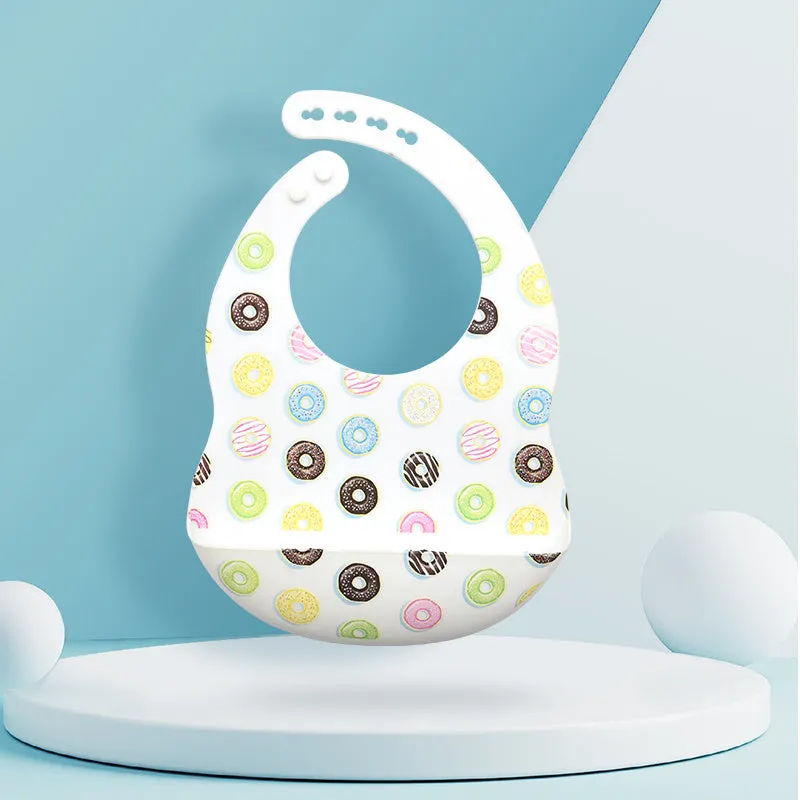 Silicone baby eating bib with adjustable neck and deep catch pocket on a child