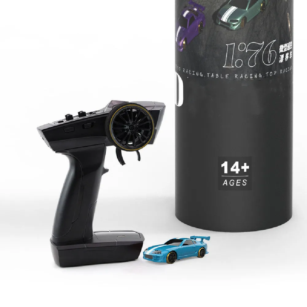 Turbo Racing 1:76 scale mini RC drift car with green body on drift track, remote control and storage box visible