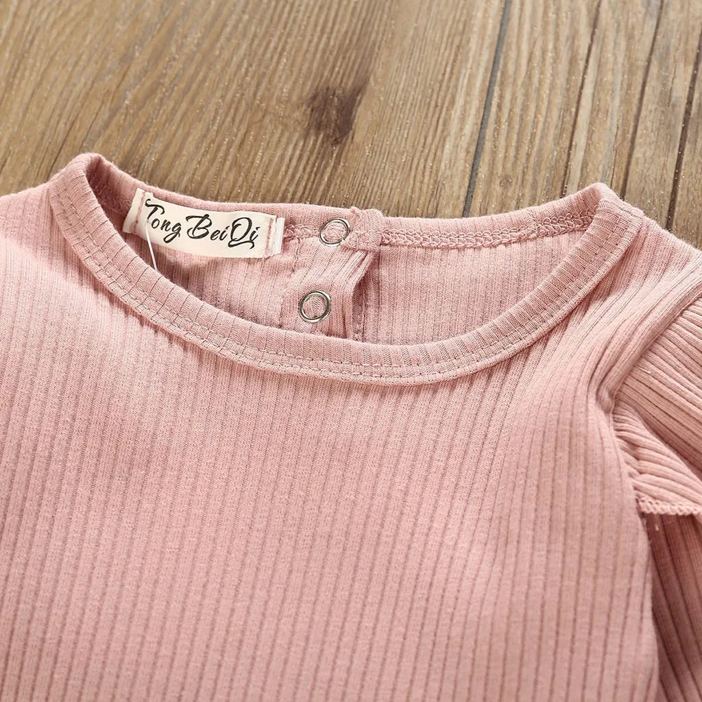 Women's pink cotton long sleeve top with size chart showing bust, length, waist measurements in centimetres