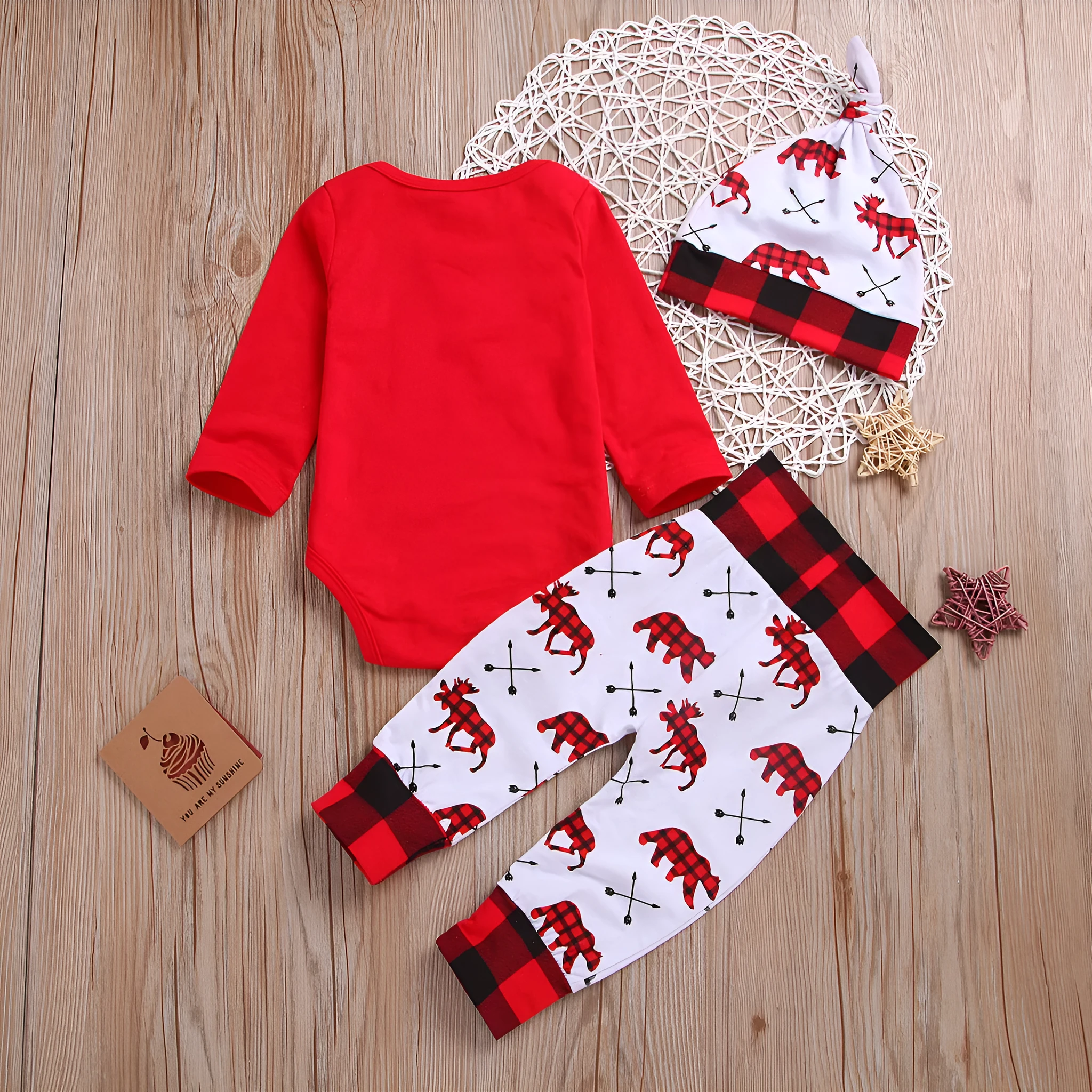 Girls' red Christmas suit with cartoon print top and trousers on white background