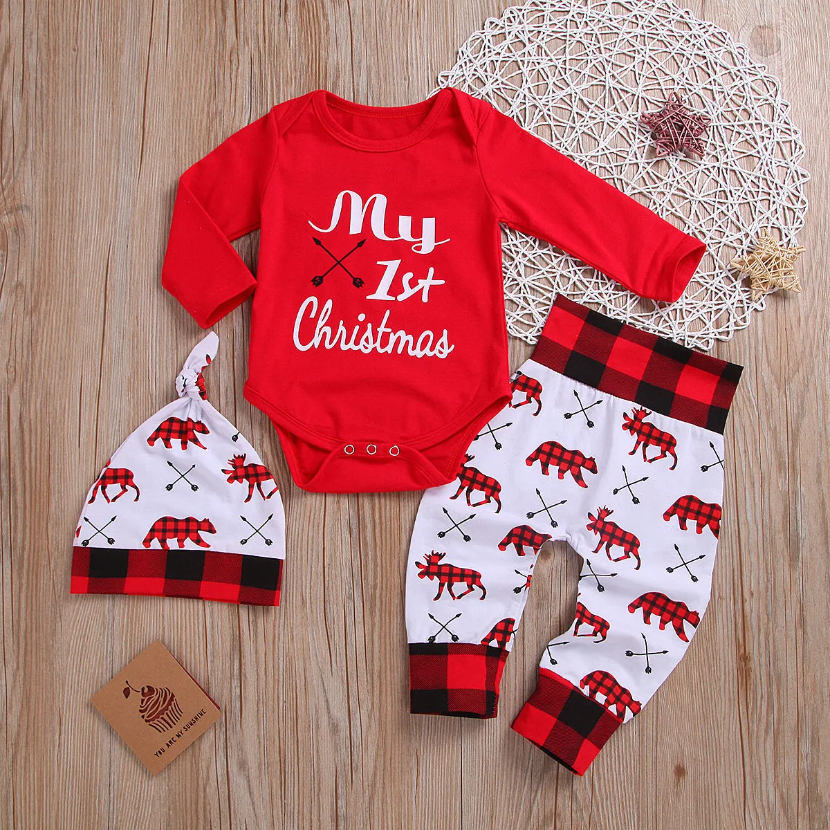 Girls' red Christmas suit with cartoon print top and trousers on white background