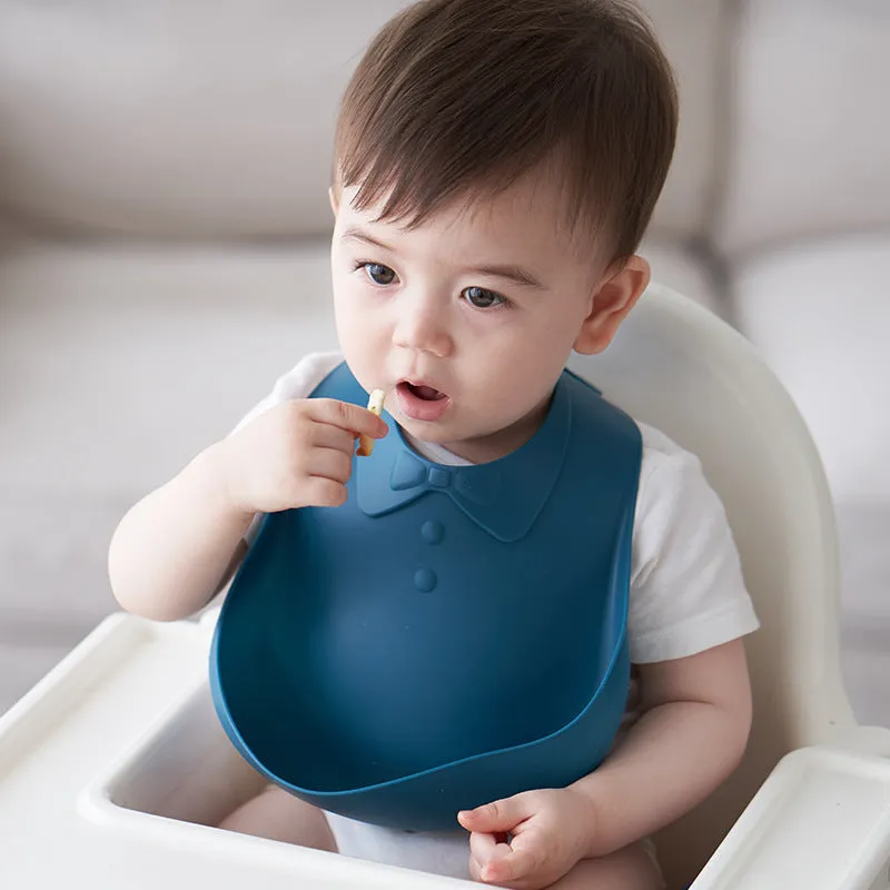 Waterproof soft plastic children bib with cartoon pattern in red, green, and blue colour options