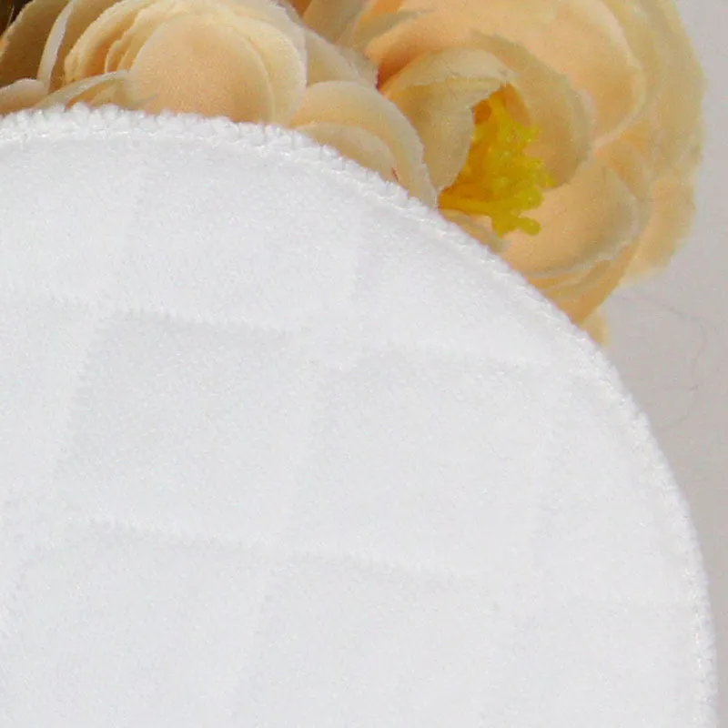 Pack of four white eco-cotton double-layer anti-galactorrhea nursing pads on a white background