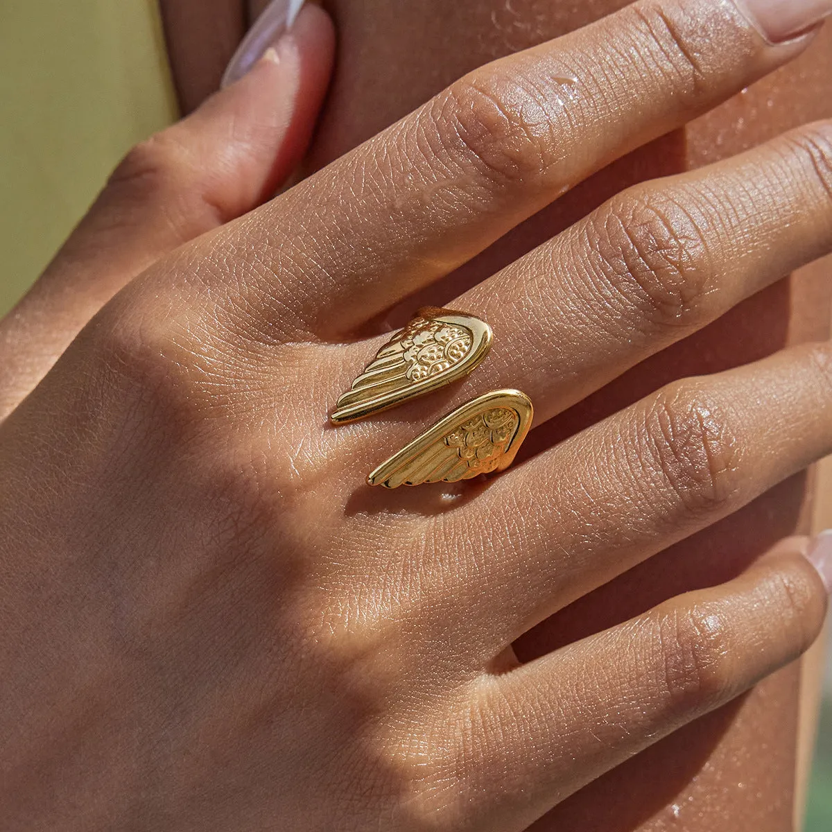 Wings design stainless steel ring with an adjustable opening, shown in a silver electroplated finish.