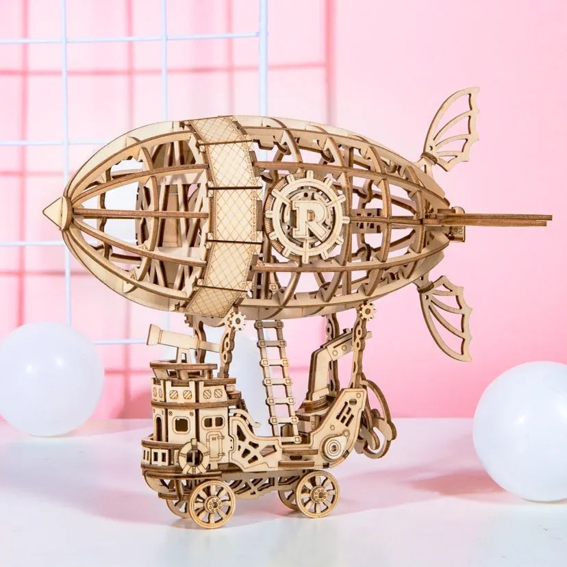 Wooden 3D puzzle model of a balloon assembled from pre-cut wood pieces on a light background