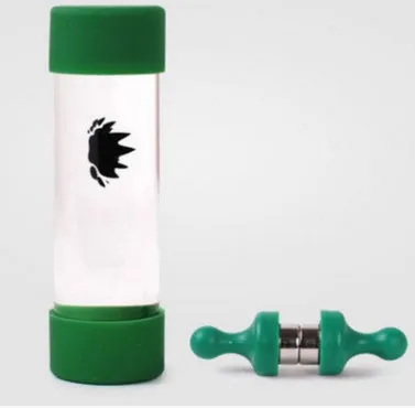 Magnetic fluid toy in a glass bottle with red ferrofluid and two black magnets on a white surface