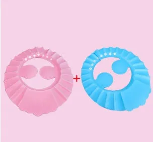 Blue baby shower cap with cartoon ear protection on a toddler's head during bath time
