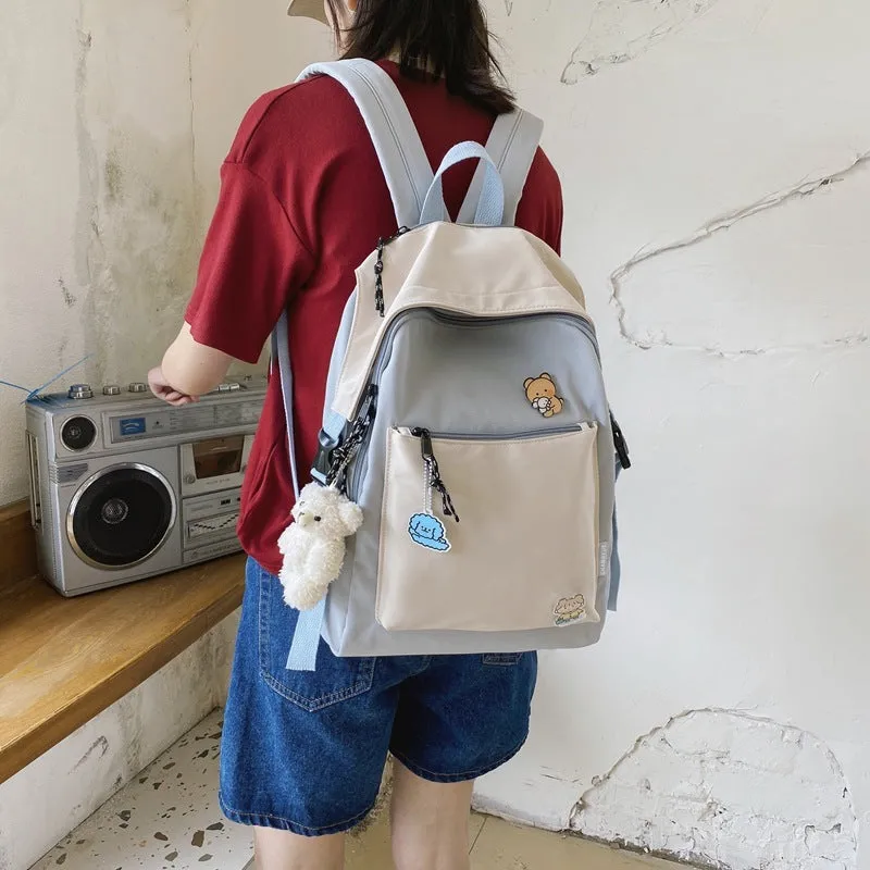 Korean style college backpack 20-35L water repellent in pink, front view