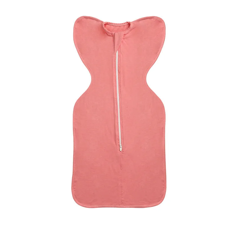 Newborn baby swaddled in bamboo fibre gauze sleeping bag with matching beanie in solid colour