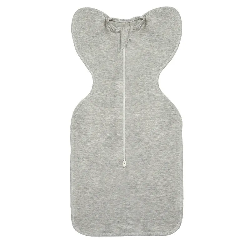 Newborn baby swaddled in bamboo fibre gauze sleeping bag with matching beanie in solid colour