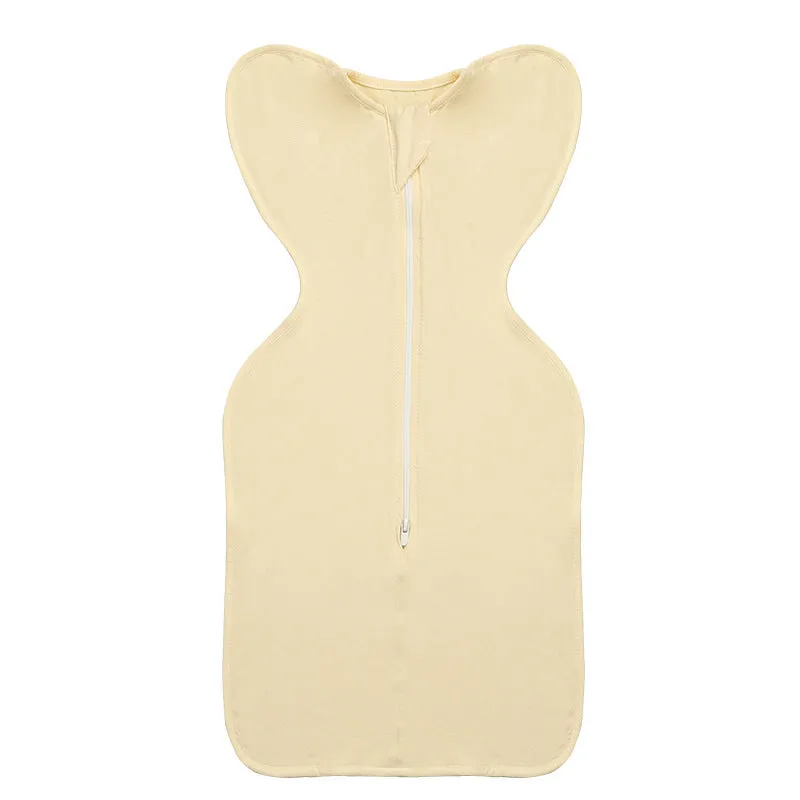 Newborn baby swaddled in bamboo fibre gauze sleeping bag with matching beanie in solid colour