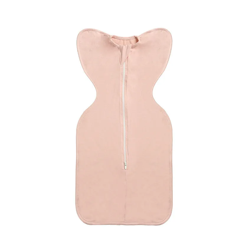 Newborn baby swaddled in bamboo fibre gauze sleeping bag with matching beanie in solid colour