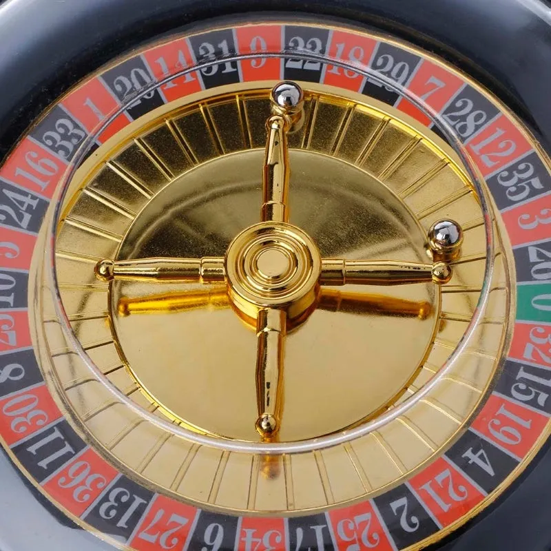 Electric Russian lucky wheel roulette wine set with spinning turntable, six glass shot glasses, and two steel balls on a table