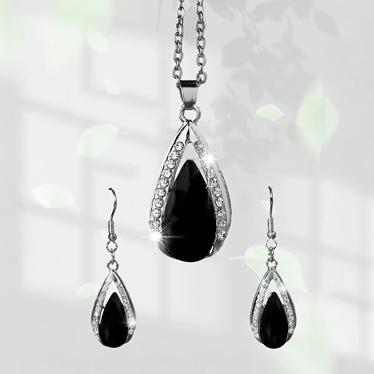 Teardrop pendant necklace and matching earrings jewellery suite in alloy with black or red glass accents