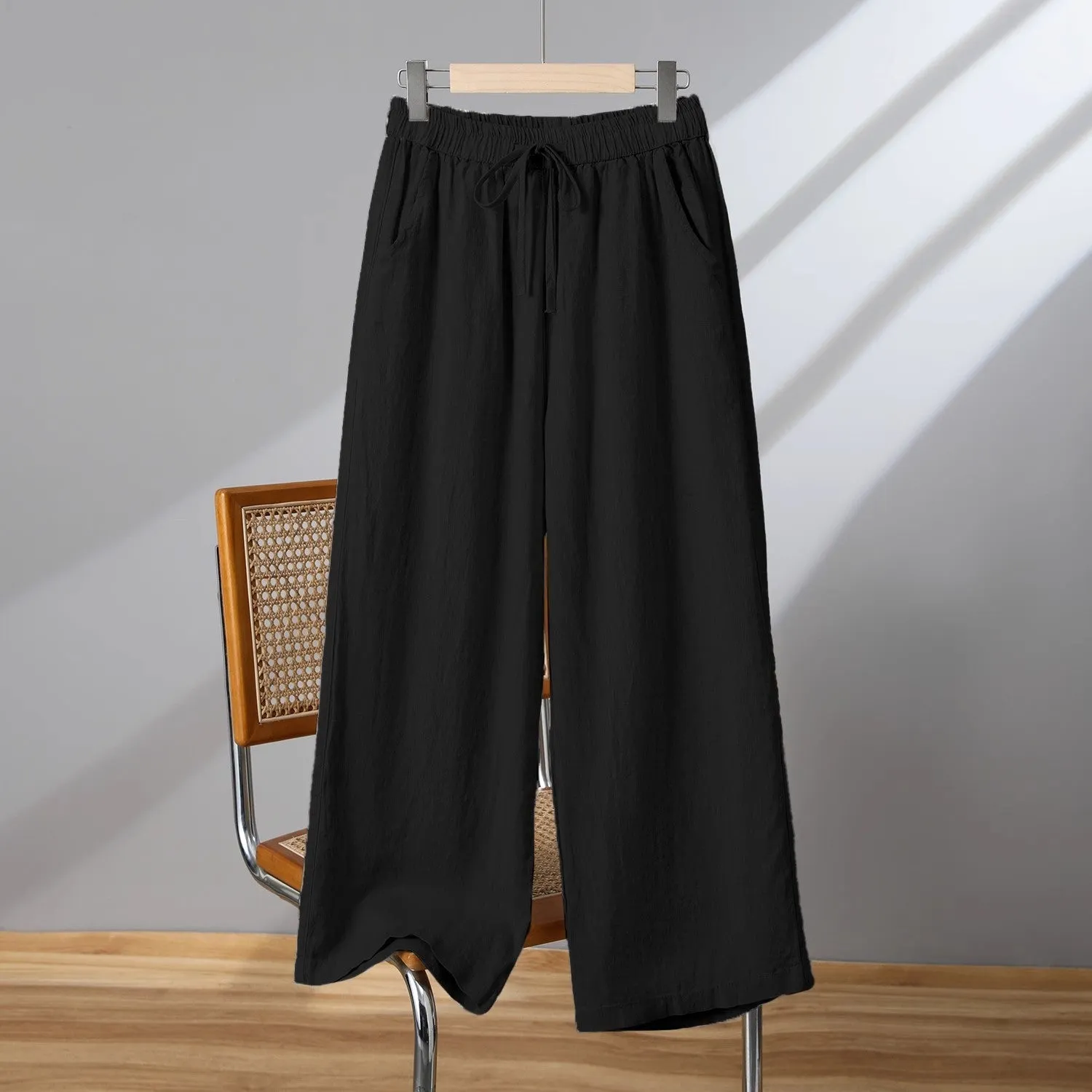Women's straight-leg casual trousers in apricot colour with a drawstring elastic waistband and lace-up detail.