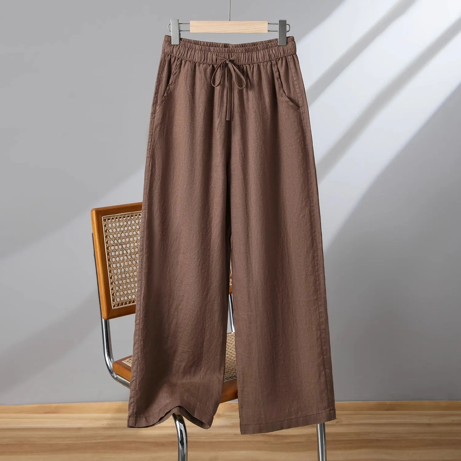Women's straight-leg casual trousers in apricot colour with a drawstring elastic waistband and lace-up detail.