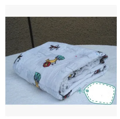 Cotton gauze baby blanket 120x120cm in balloon elephant style folded on a light background