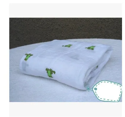 Cotton gauze baby blanket 120x120cm in balloon elephant style folded on a light background