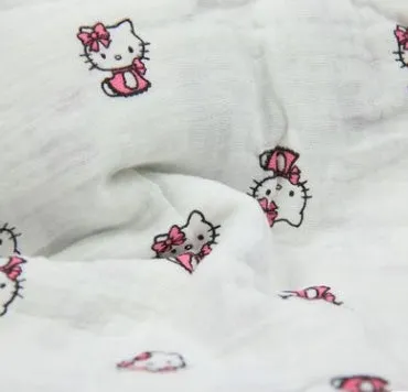 Cotton gauze baby blanket 120x120cm in balloon elephant style folded on a light background