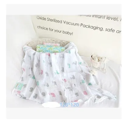 Cotton gauze baby blanket 120x120cm in balloon elephant style folded on a light background