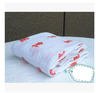Cotton gauze baby blanket 120x120cm in balloon elephant style folded on a light background