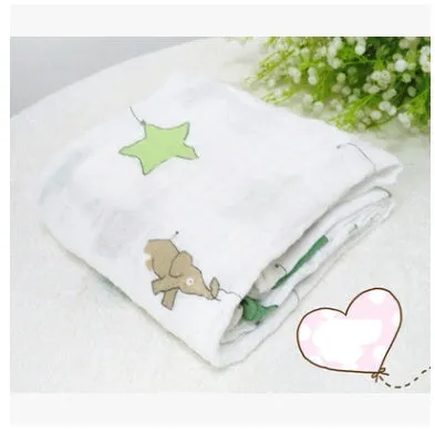 Cotton gauze baby blanket 120x120cm in balloon elephant style folded on a light background