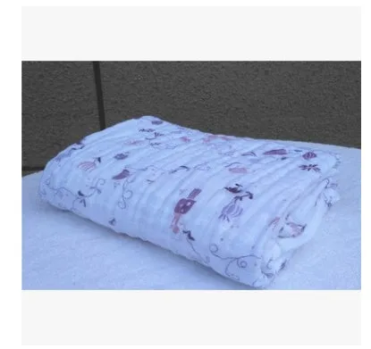 Cotton gauze baby blanket 120x120cm in balloon elephant style folded on a light background