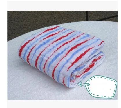Cotton gauze baby blanket 120x120cm in balloon elephant style folded on a light background