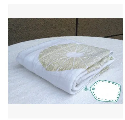 Cotton gauze baby blanket 120x120cm in balloon elephant style folded on a light background