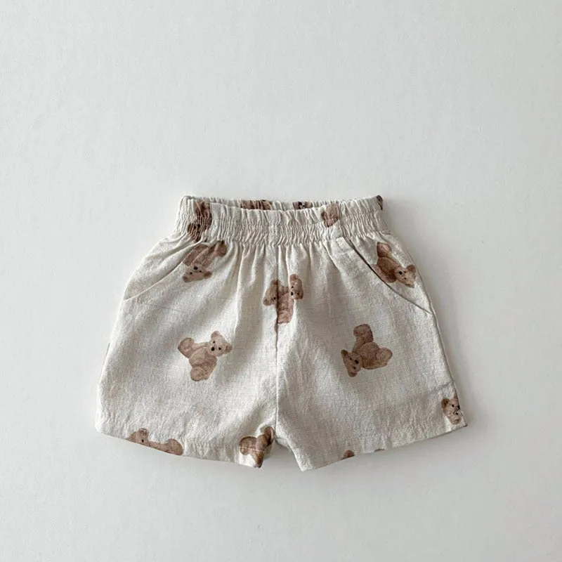 Baby loose thin cotton and linen shorts in black with elastic waist, side view on white background