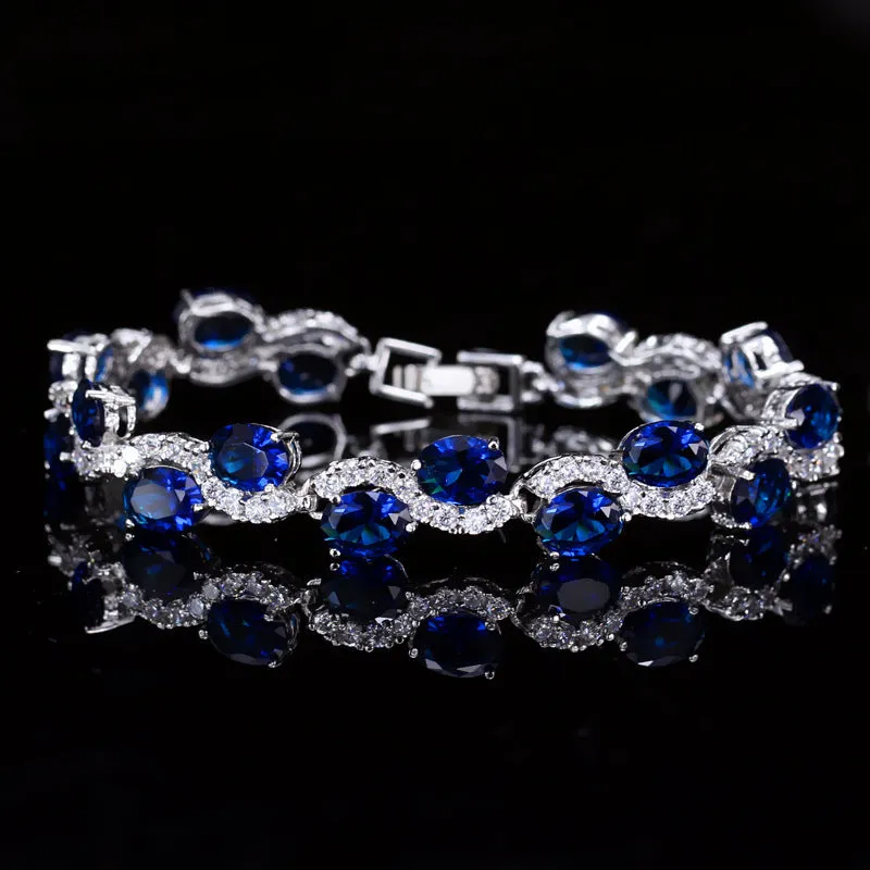 Geometric gold electroplated women's bracelet with inlaid AAA+ zircon stones on a copper base.