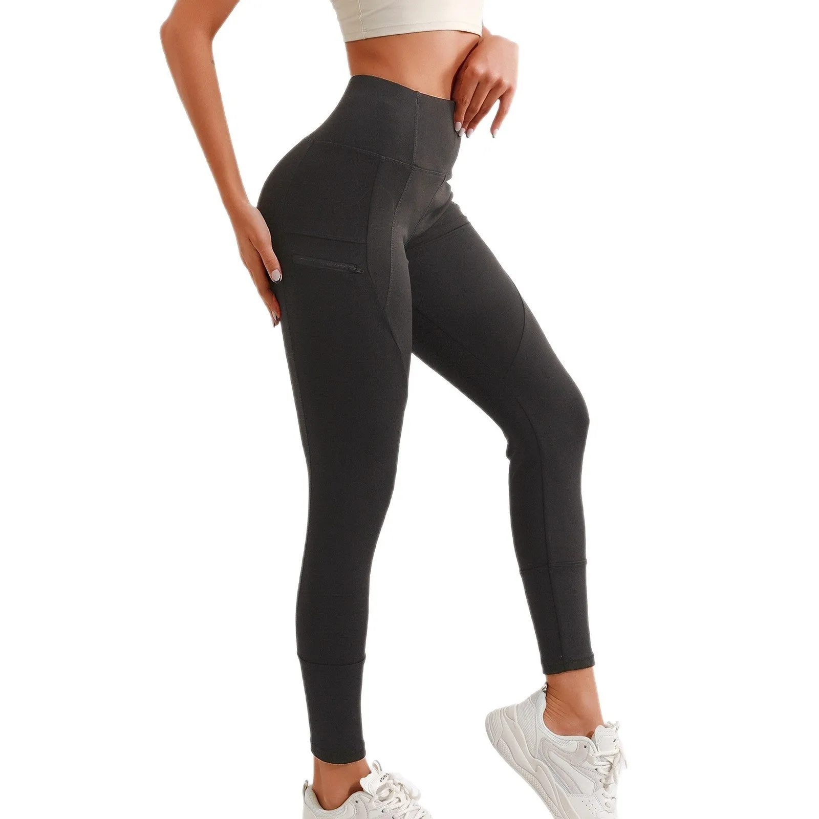 Black cropped leggings with high waist and zipper pocket on a model