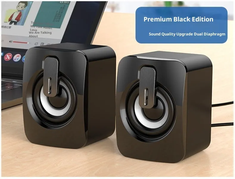 A pair of black plastic USB mini multimedia speakers with wired connection