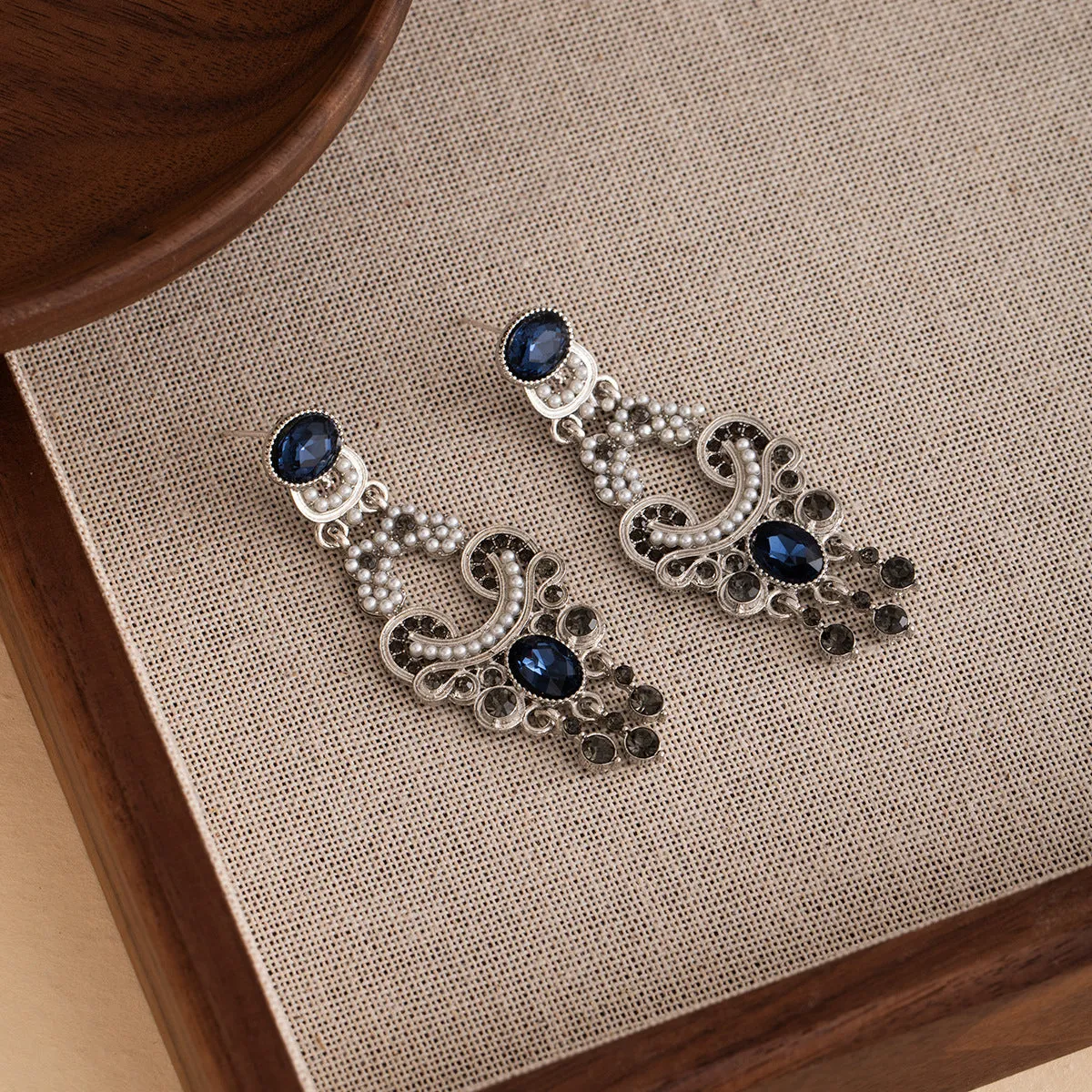 Vintage court style earrings with atmospheric blue crystal and chamfered square grain geometric shape in E7744 colour