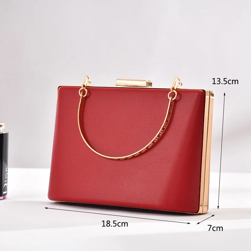Solid colour PU leather crossbody bag in pillow shape with double-ring detail, 18.5x13.5x7cm, in black.