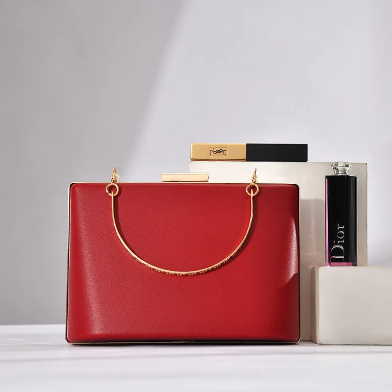 Solid colour PU leather crossbody bag in pillow shape with double-ring detail, 18.5x13.5x7cm, in black.