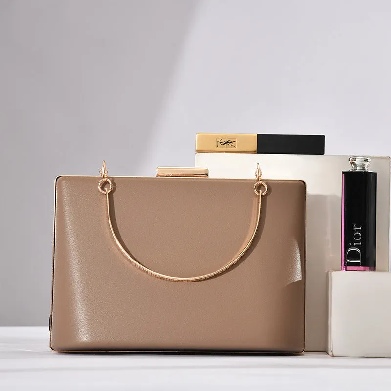 Solid colour PU leather crossbody bag in pillow shape with double-ring detail, 18.5x13.5x7cm, in black.
