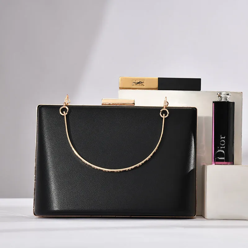 Solid colour PU leather crossbody bag in pillow shape with double-ring detail, 18.5x13.5x7cm, in black.