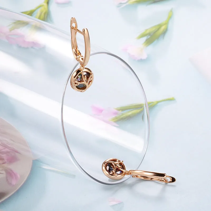 Rose gold plated copper drop earrings with artificial gemstone inlay on white background