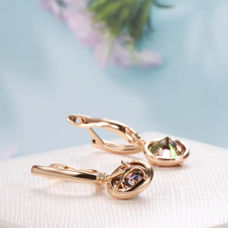 Rose gold plated copper drop earrings with artificial gemstone inlay on white background