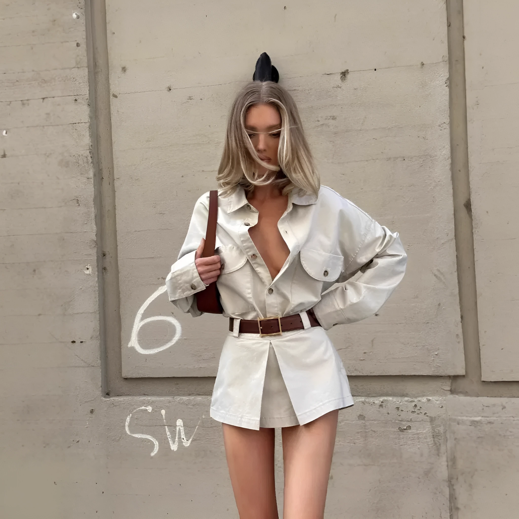 Grey long sleeve button front shirt dress with low waist and fake pocket details on a model