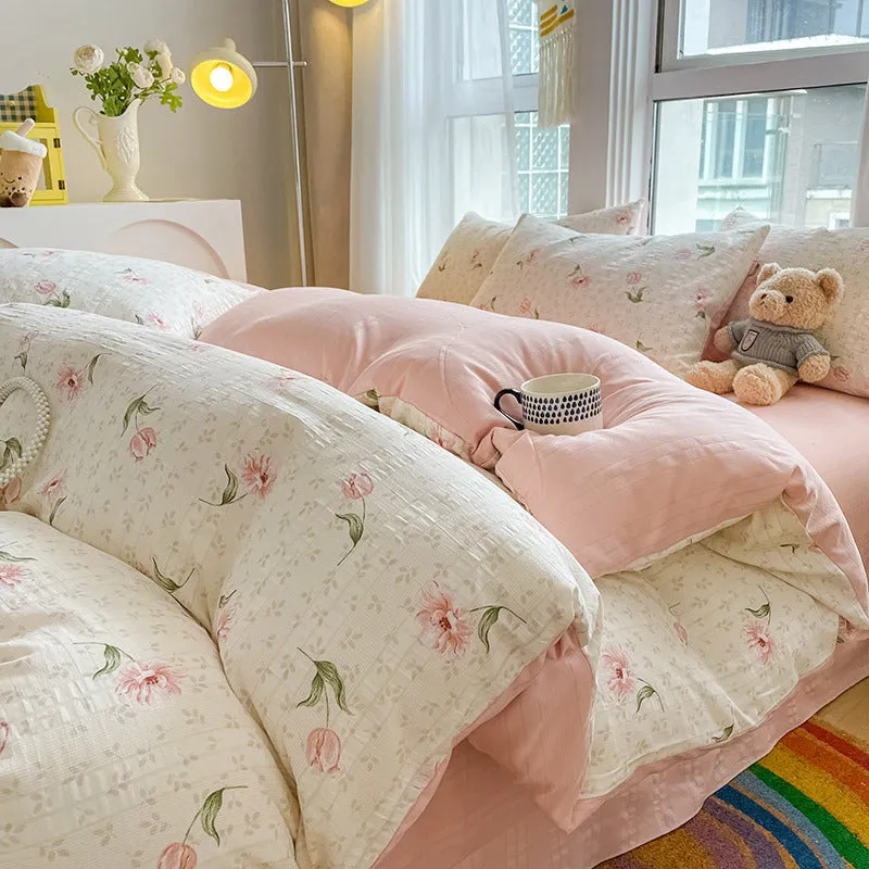Aerobic jacquard cloud yarn four-piece bedding set with quilt cover, sheet, and pillowcases in a soft pattern.