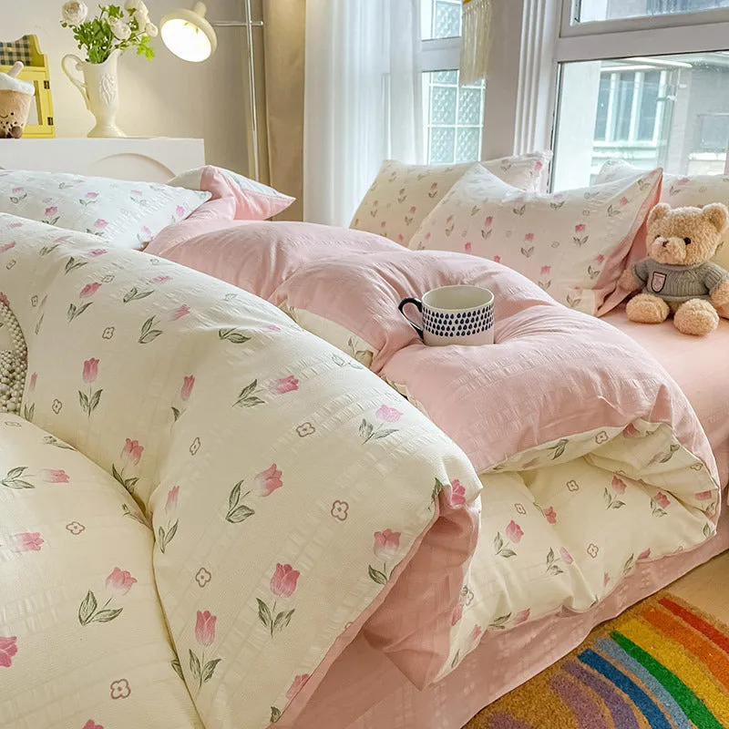 Aerobic jacquard cloud yarn four-piece bedding set with quilt cover, sheet, and pillowcases in a soft pattern.