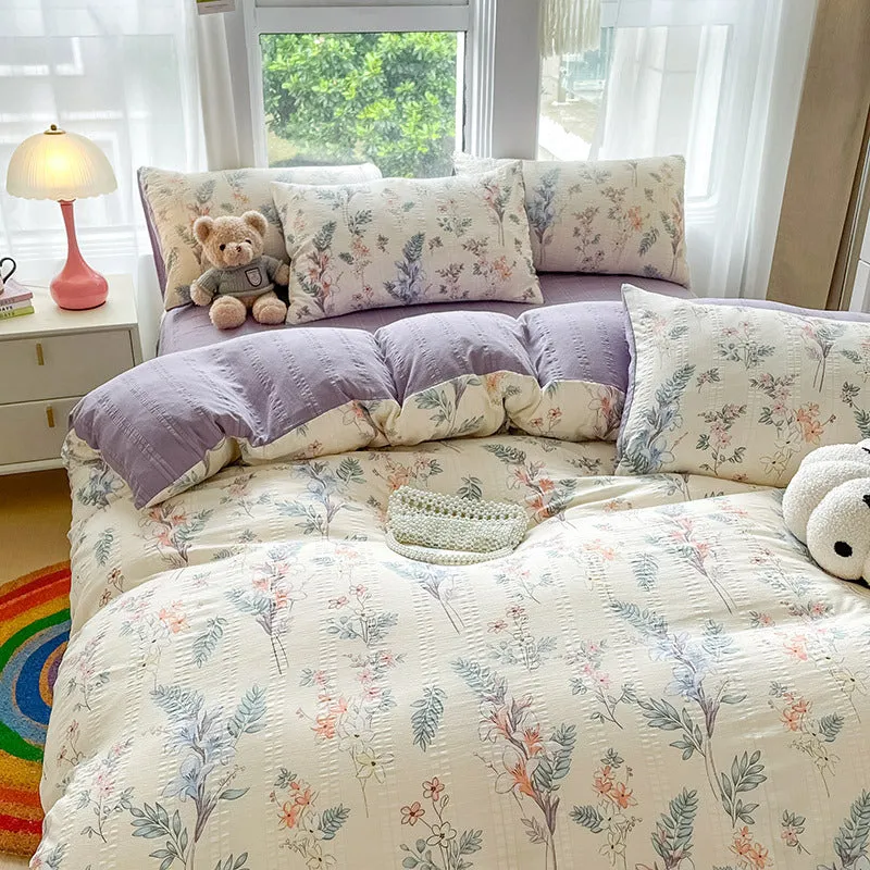 Aerobic jacquard cloud yarn four-piece bedding set with quilt cover, sheet, and pillowcases in a soft pattern.