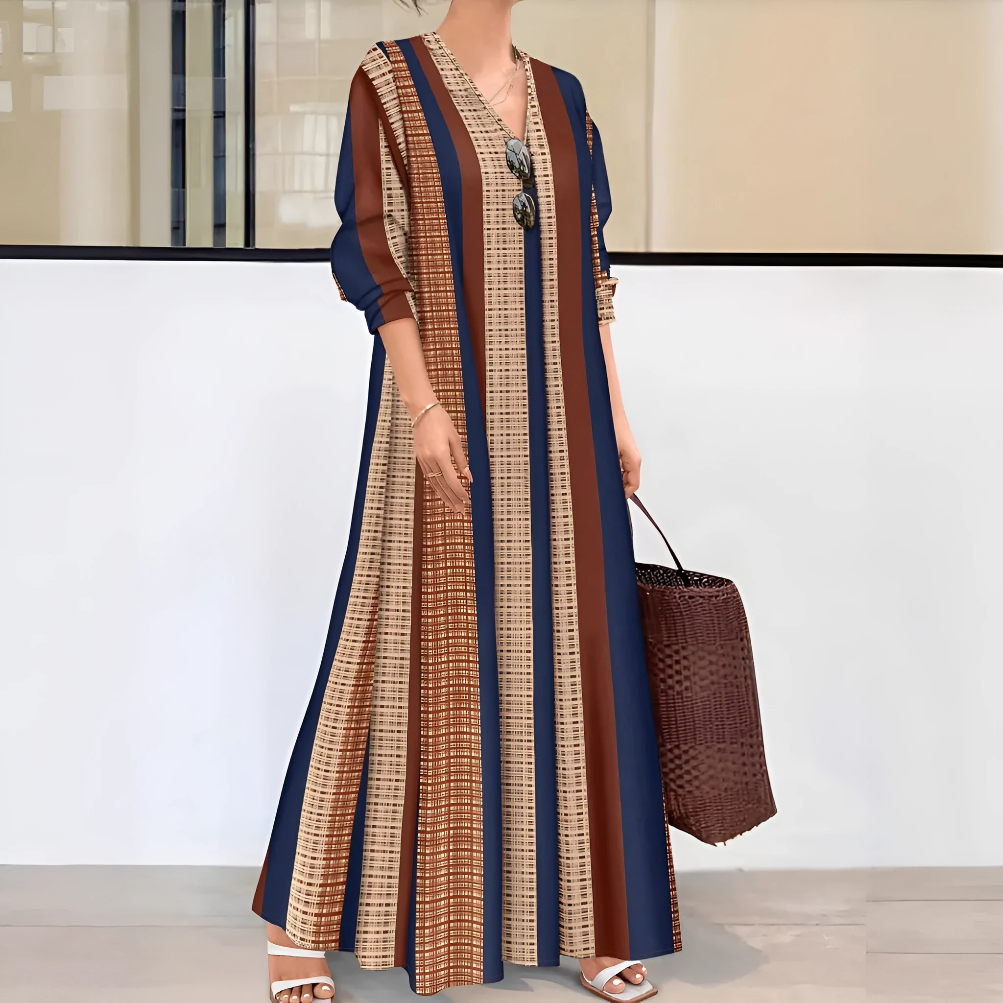 Women's camel coloured knitted dress with vertical stripes, V-neck, and long A-line silhouette