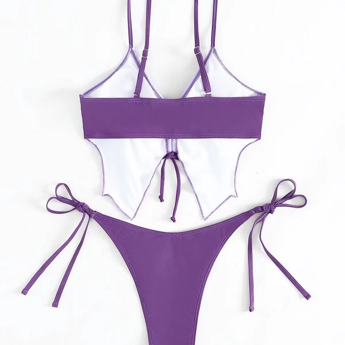Women's purple bow ins style split bikini suit top and briefs on a mannequin.