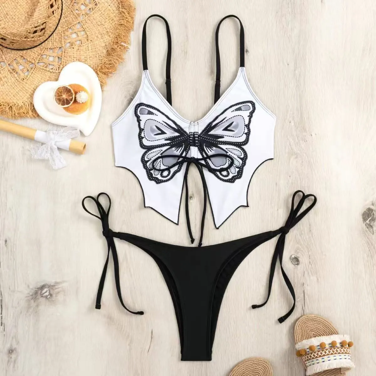 Women's purple bow ins style split bikini suit top and briefs on a mannequin.