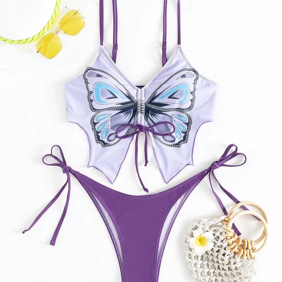 Women's purple bow ins style split bikini suit top and briefs on a mannequin.
