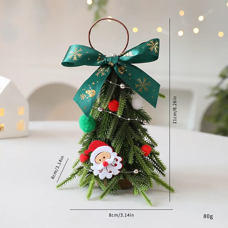 Mini Christmas tree ornament in red and white snowflake design on a tree branch