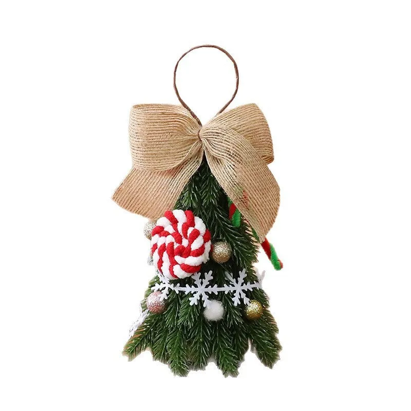 Mini Christmas tree ornament in red and white snowflake design on a tree branch